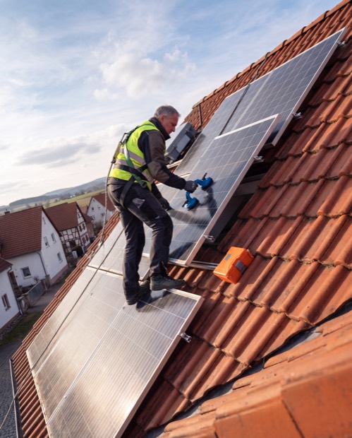 Dachdecker montiert eine Solaranlage
